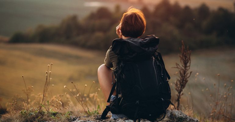 Woman sitting on the mountain